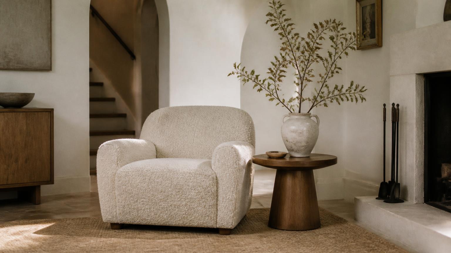 Styled transitional sitting room corner with boucle armchair and oak side table